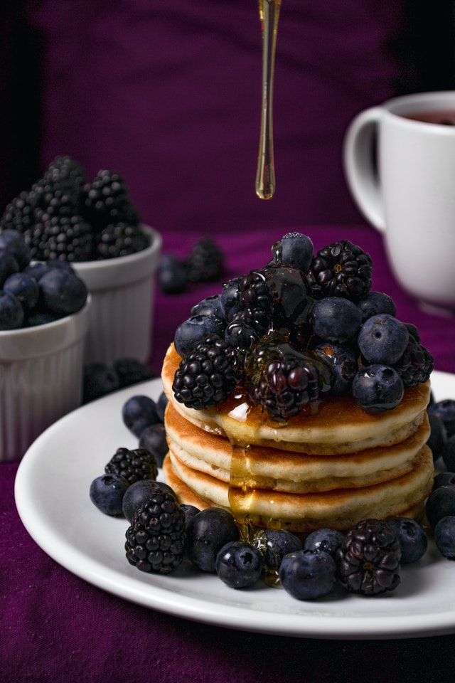 berries, grapes and pancakes with honey